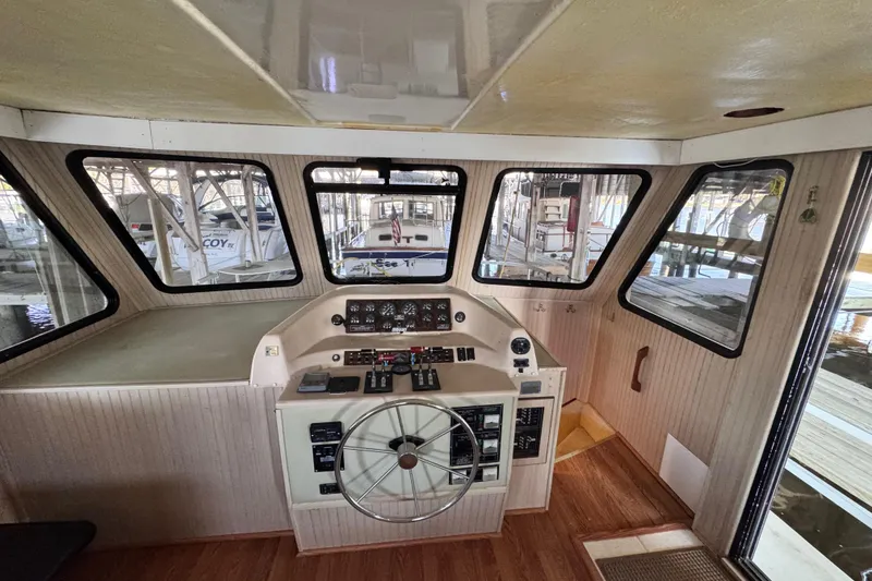 Slide: The Image of helm and to the right of the helm a stairway leading down to the forward head, storage areas and a twin berth - 66