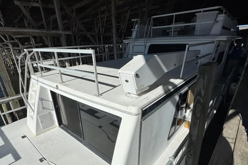 Slide: The Image of 1999 Gibson Houseboat 50 docked in a covered marina. - 7