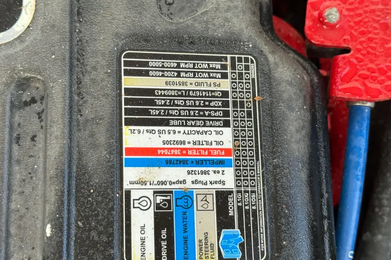 Slide: The Image of Label on engine component of 1999 Gibson Houseboat 50, showing specifications and maintenance details. - 74