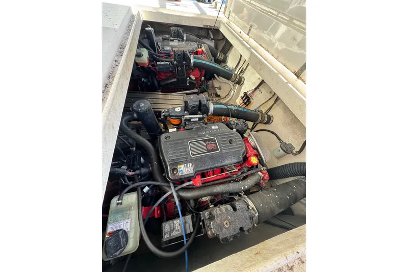 Slide: The Image of Engine compartment of a 1999 Gibson Houseboat 50, showcasing dual inboard motors. - 76
