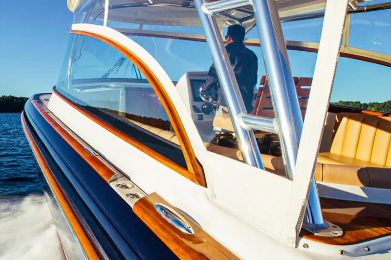 Slide: The Image of 2013 Intrepid 400 Cuddy cruising on water, featuring sleek design and luxurious seating. - 10