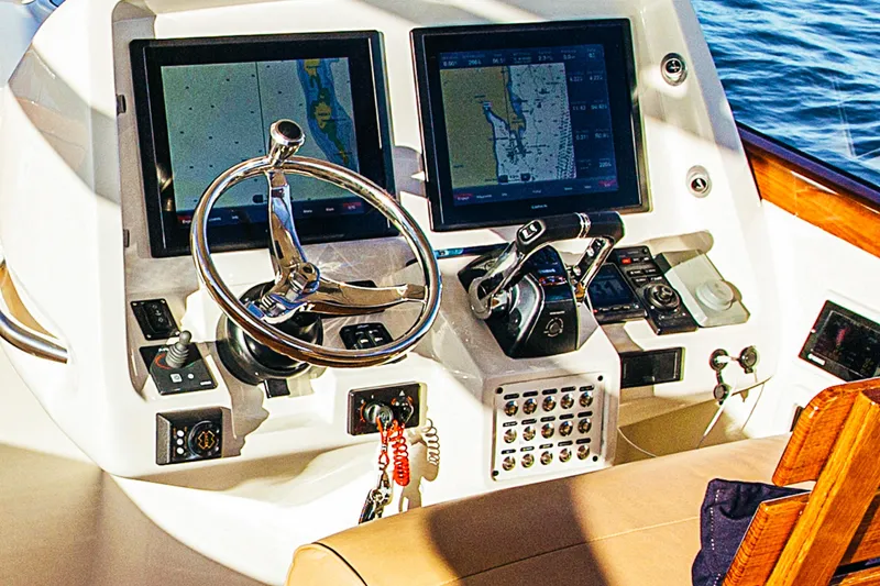 Slide: The Image of Helm of 2013 Intrepid 400 Cuddy with dual navigation screens and steering wheel. - 11