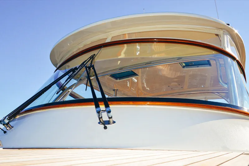Slide: The Image of 2013 Intrepid 400 Cuddy boat with sleek windshield and wipers against clear blue sky. - 12