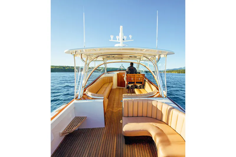 Slide: The Image of 2013 Intrepid 400 Cuddy cruising on calm waters, featuring spacious seating and sleek design. - 16