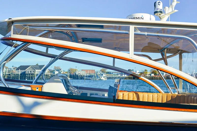 Slide: The Image of 2013 Intrepid 400 Cuddy boat with sleek design, docked by waterfront buildings. - 18