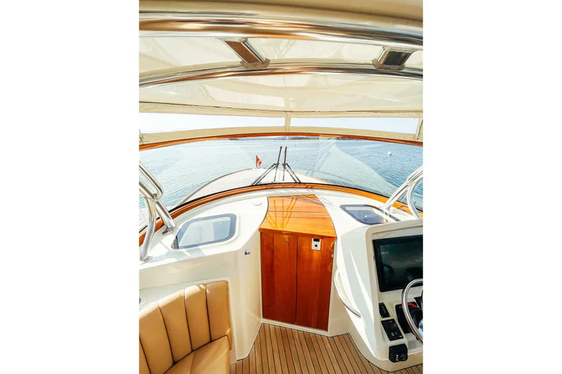 Slide: The Image of Interior view of 2013 Intrepid 400 Cuddy boat, featuring helm and seating area. - 19
