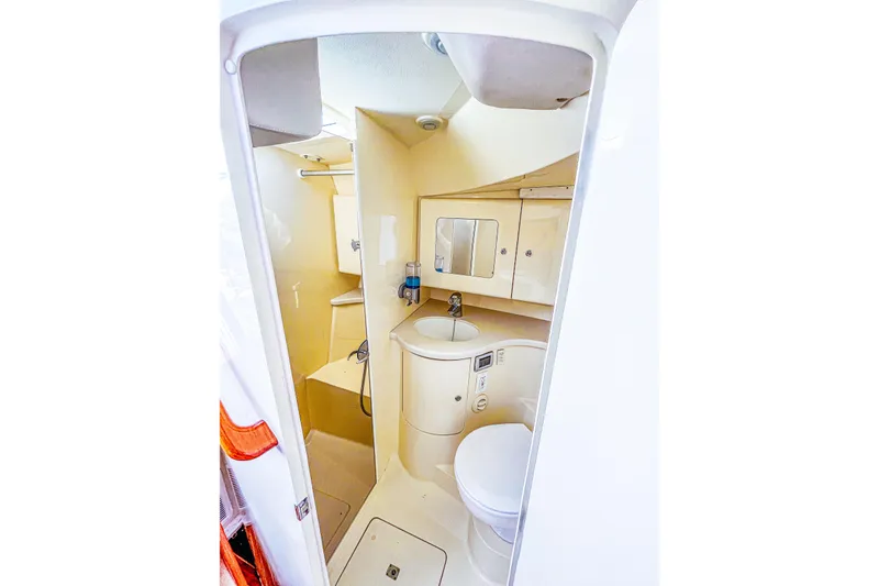 Slide: The Image of 2013 Intrepid 400 Cuddy boat bathroom with sink, toilet, and storage cabinets. - 20
