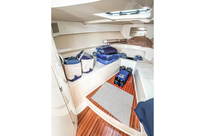 Slide: The Image of 2013 Intrepid 400 Cuddy cabin interior with storage and wooden flooring. - 21