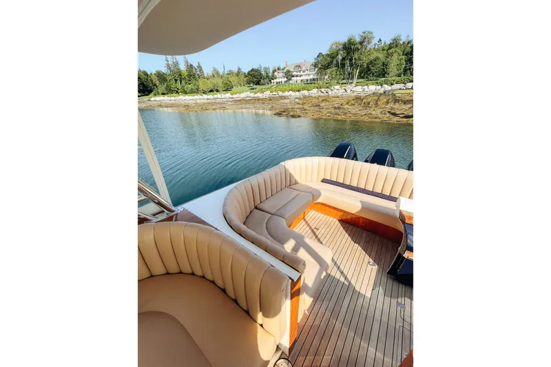 Slide: The Image of Luxurious 2013 Intrepid 400 Cuddy boat interior with plush seating, docked by scenic shoreline. - 6