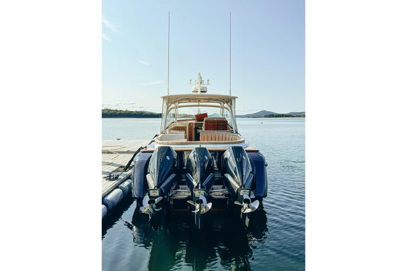 Slide: The Image of 2013 Intrepid 400 Cuddy boat docked with triple outboard engines. - 7