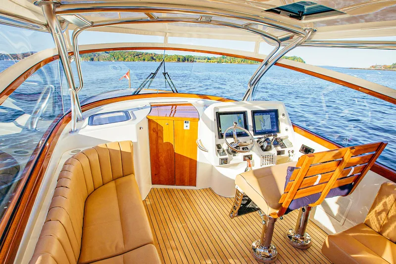 Slide: The Image of Luxurious 2013 Intrepid 400 Cuddy boat interior with navigation system and plush seating. - 9