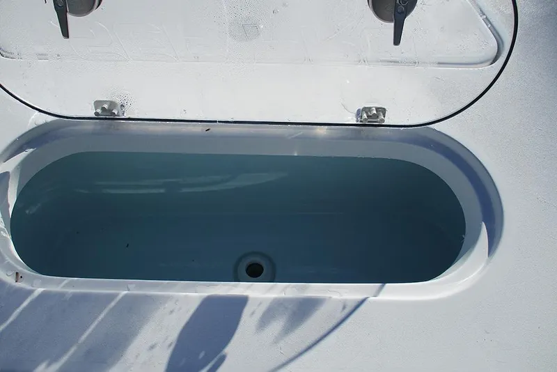 Slide: The Image of Livewell on 2026 Sea Pro 250 Bay boat, open lid, filled with water. - 18