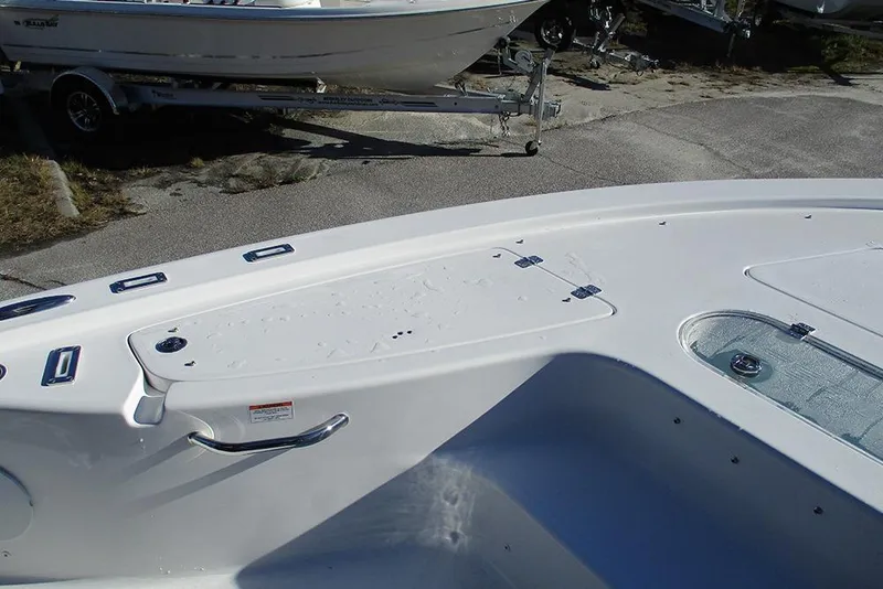 Slide: The Image of 2026 Sea Pro 250 Bay boat deck with storage compartments and sleek design. - 23