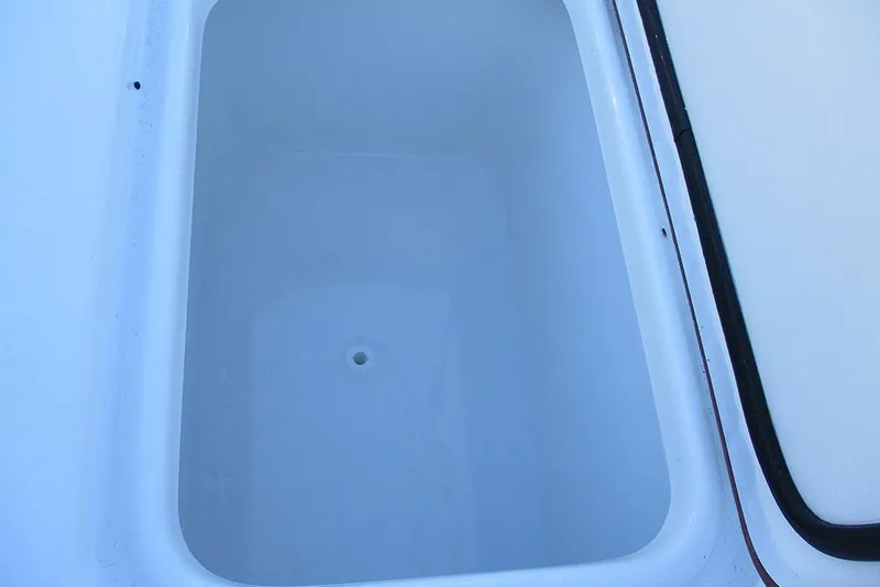 Slide: The Image of Storage compartment of 2026 Sea Pro 250 Bay boat, featuring a clean, white interior. - 28