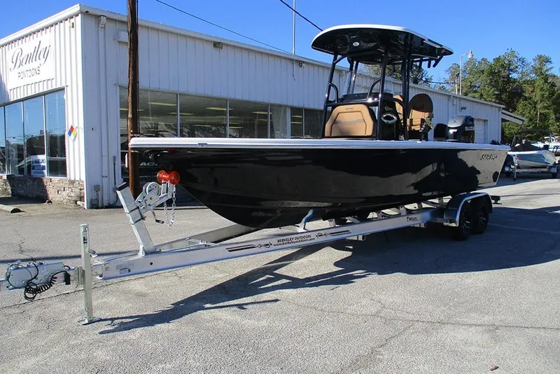 Slide: The Image of 2026 Sea Pro 250 Bay boat on trailer outside Bentley Pontoons dealership. - 3