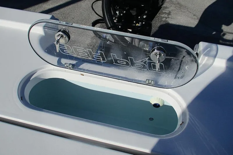 Slide: The Image of 2026 Sea Pro 250 Bay boat livewell with transparent lid and secure latches. - 30
