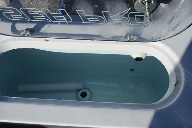 Slide: The Image of Livewell in 2026 Sea Pro 250 Bay boat, open lid, water inside. - 31