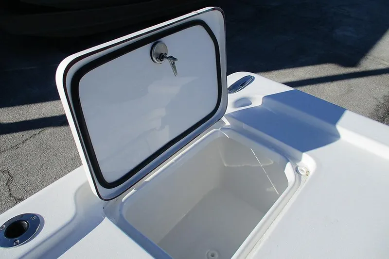Slide: The Image of 2026 Sea Pro 250 Bay boat storage compartment with open hatch and key lock. - 33