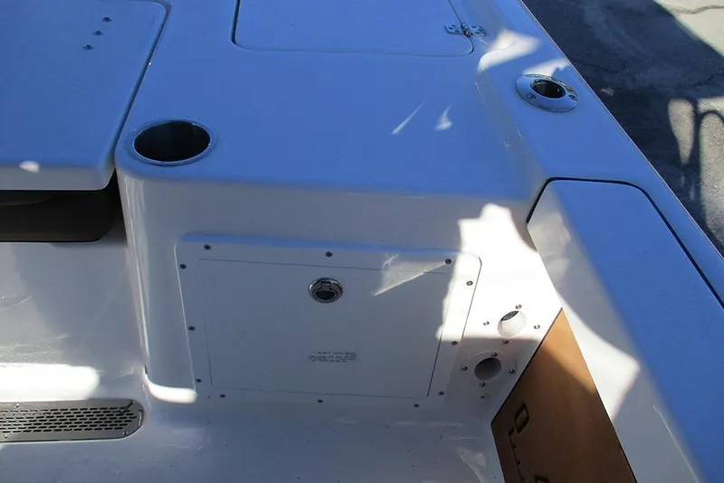 Slide: The Image of 2026 Sea Pro 250 Bay boat deck with storage compartment and cup holders. - 35