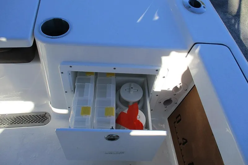 Slide: The Image of Storage compartment on a 2026 Sea Pro 250 Bay boat, featuring organized tackle boxes. - 36