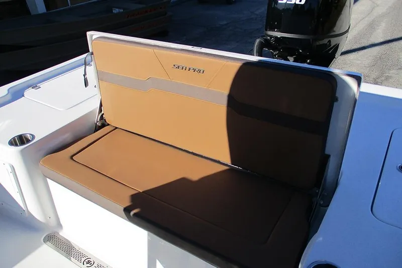 Slide: The Image of 2026 Sea Pro 250 Bay boat with tan seating and motor in sunlight. - 42