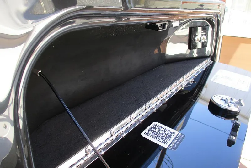 Slide: The Image of Storage compartment of 2026 Sea Pro 250 Bay boat with QR code and latch details. - 46