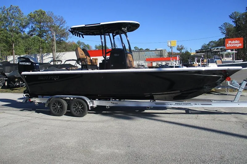 Slide: The Image of 2026 Sea Pro 250 Bay boat on trailer, parked outdoors near storage facility. - 6