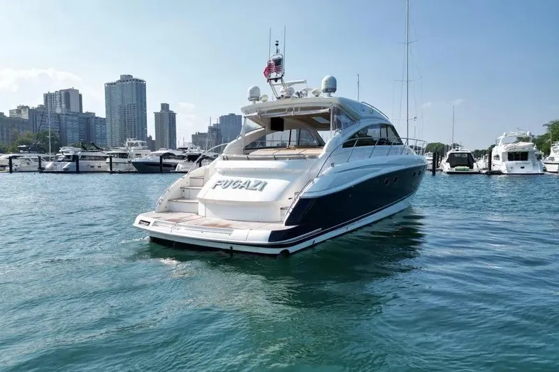 Slide: The Image of 2008 Princess V53 yacht docked in marina with city skyline in background. - 15