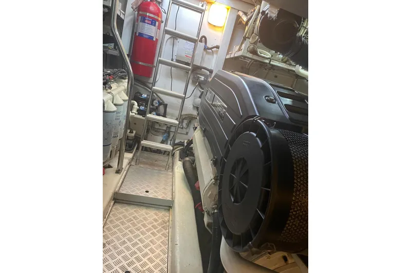 Slide: The Image of Engine room of 2008 Princess V53 yacht with visible equipment and fire extinguisher. - 25