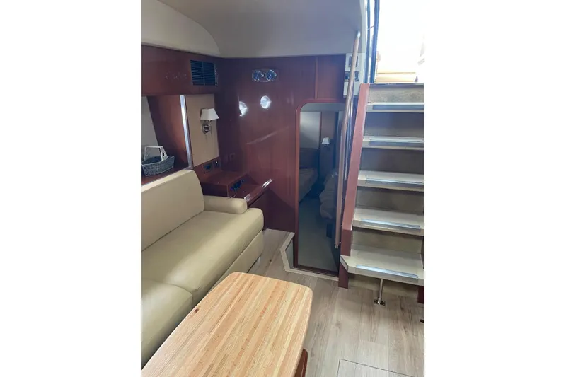 Slide: The Image of Interior of 2008 Princess V53 yacht with beige seating and wooden accents. - 26