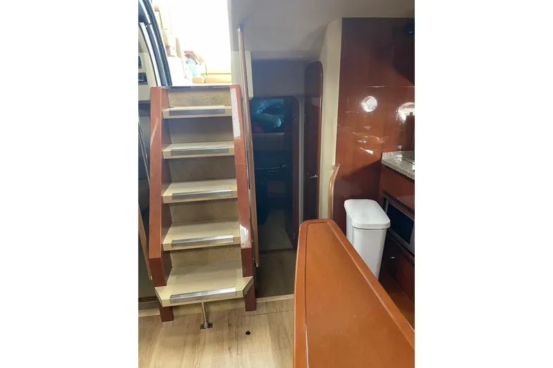 Slide: The Image of Interior of 2008 Princess V53 yacht with wooden stairs and modern kitchen area. - 27