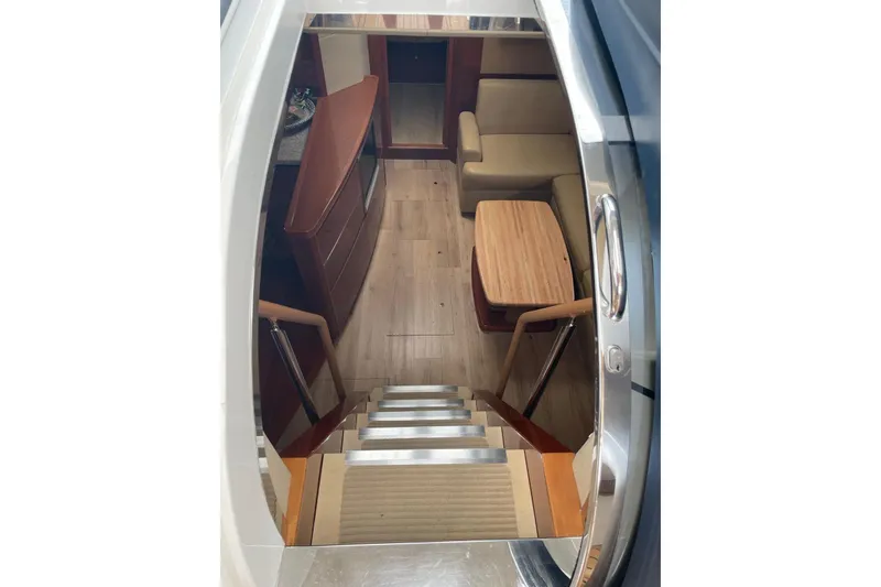 Slide: The Image of Interior view of 2008 Princess V53 yacht, featuring wooden stairs and seating area. - 30