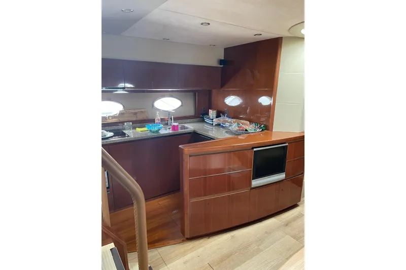 Slide: The Image of Luxurious kitchen interior of 2008 Princess V53 yacht with modern amenities and wood finish. - 37