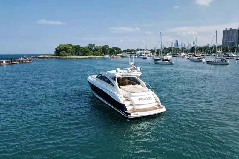 Slide: The Image of 2008 Princess V53 yacht on serene water with city skyline and sailboats in background. - 5