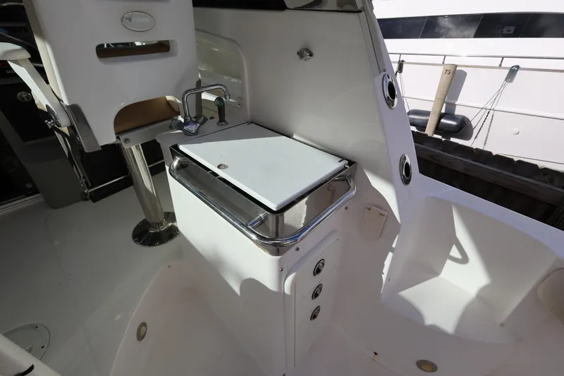 Slide: The Image of 2011 Everglades 320EX boat interior with sink and seating area. - 10