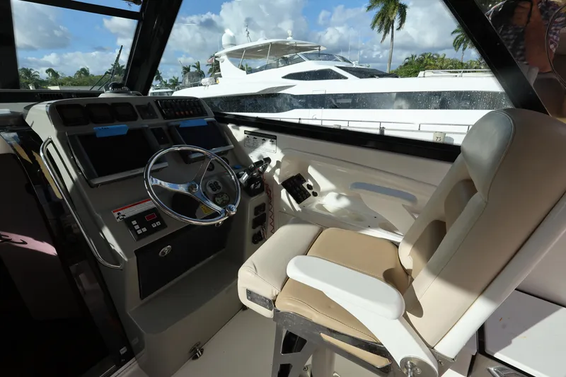 Slide: The Image of Cockpit of 2011 Everglades 320EX boat with steering wheel and control panel. - 12