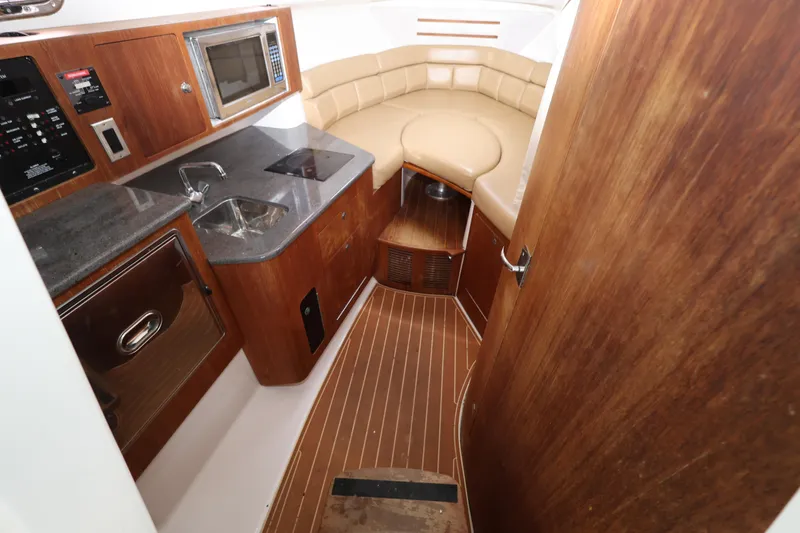 Slide: The Image of 2011 Everglades 320EX cabin interior with kitchenette and seating area. - 16
