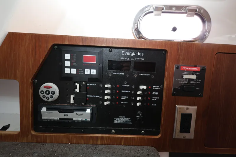 Slide: The Image of Control panel of a 2011 Everglades 320EX boat, featuring various switches and displays. - 20