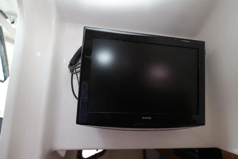 Slide: The Image of Small TV screen inside 2011 Everglades 320EX boat cabin. - 21