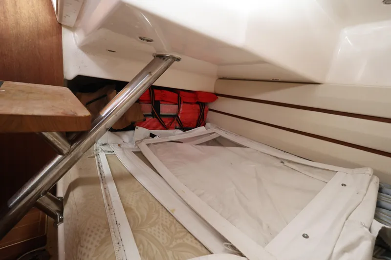 Slide: The Image of Interior storage area of a 2011 Everglades 320EX boat with life jackets and equipment. - 23