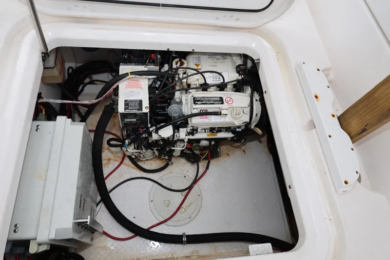Slide: The Image of Engine compartment of a 2011 Everglades 320EX boat, showing mechanical components and wiring. - 25