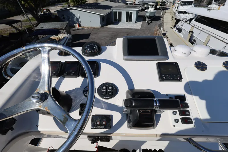 Slide: The Image of Control panel of 2011 Everglades 320EX boat with steering wheel and navigation instruments. - 28