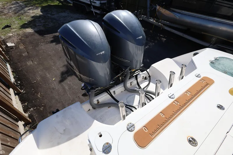 Slide: The Image of 2011 Everglades 320EX boat with dual outboard engines and fishing rod holders. - 30
