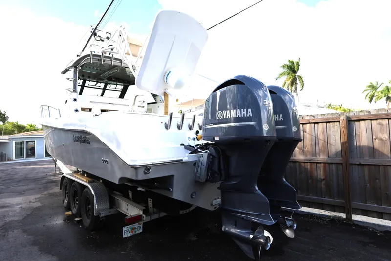 Slide: The Image of 2011 Everglades 320EX boat with Yamaha engines on trailer, parked outdoors. - 4