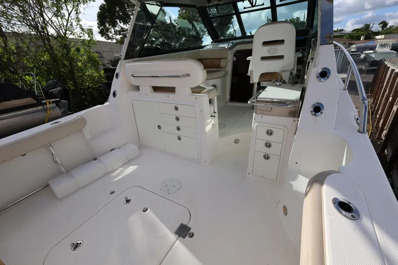 Slide: The Image of 2011 Everglades 320EX boat interior with seating, storage, and helm station. - 9