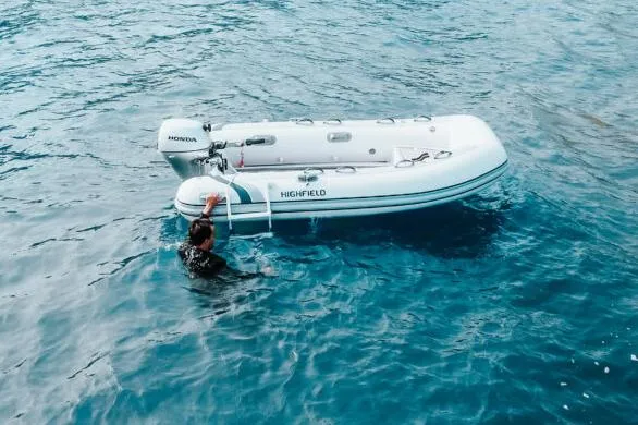 The Image of Manufacturer Provided Image: 2025 Highfield Classic 290 inflatable boat on water with person climbing aboard. - 0