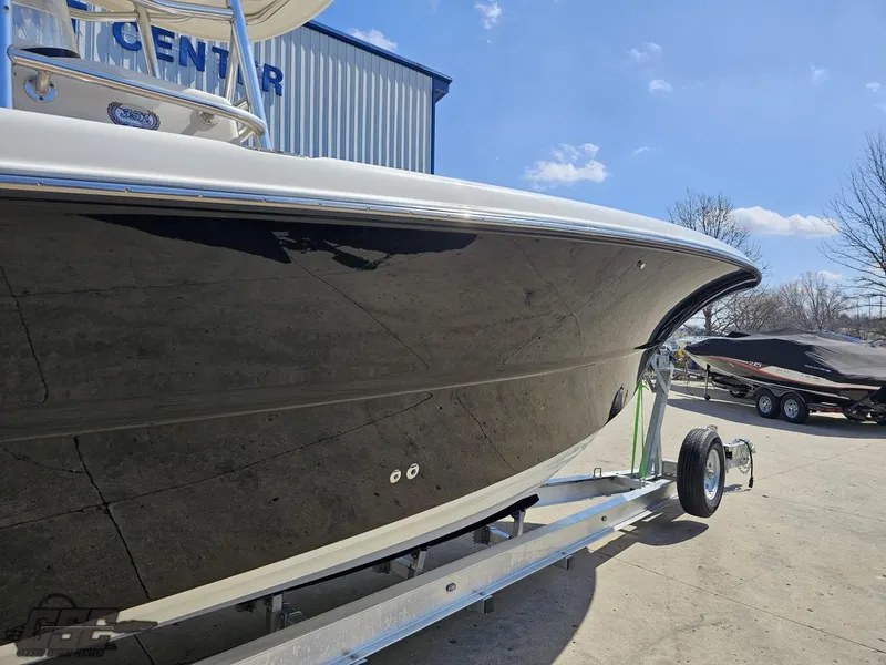 Slide: The Image of 2007 Triton 351 CC boat on trailer outside a marine center. - 10