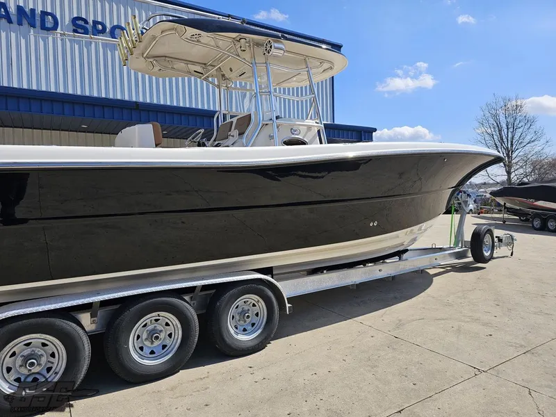 Slide: The Image of 2007 Triton 351 CC boat on a trailer outside a building. - 12