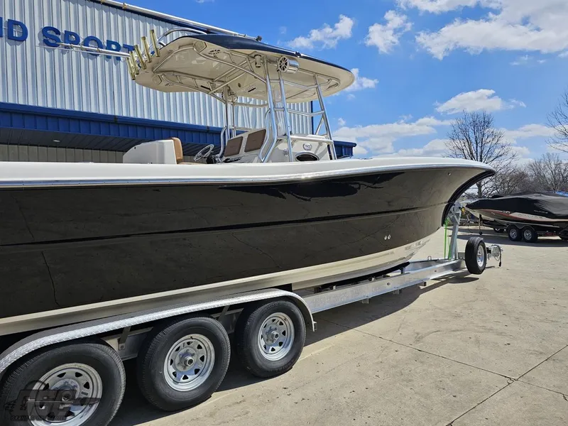 Slide: The Image of 2007 Triton 351 CC boat on a trailer outside a building under a blue sky. - 15