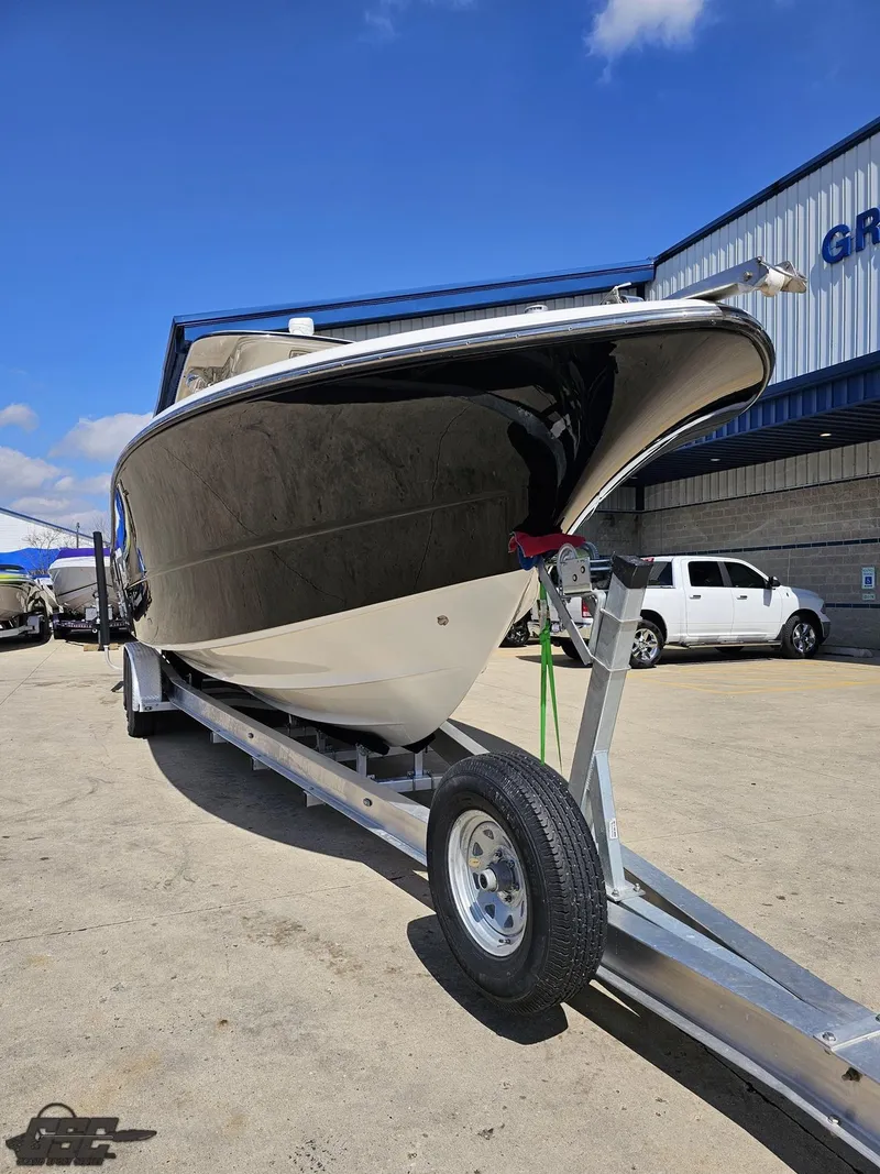 Slide: The Image of 2007 Triton 351 CC boat on a trailer outside a building. - 17